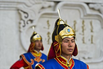 Guardian of the Mongolian armed forces in traditional uniforms in front of the Dschingis-Khan monument at the parliament building