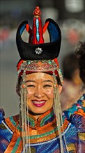 Young woman in traditional Deel clothes and hat with the typical conical tip