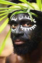 Korafe-Man with facial painting and headdress made of leaves