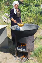 Kazakh Woman preparing traditional local tandyr bread