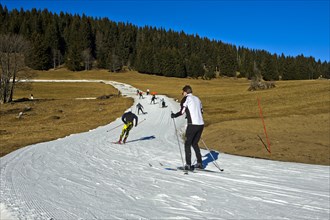 Cross country skiers on artificial snow trail