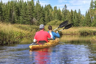 Two men paddling in a kayak