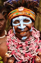 Woman of the Marowa Welda group applying make-up for the annual Sing Sing in Goroka