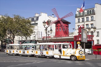 Tourist train in front of Variete Theater Moulin Rouge