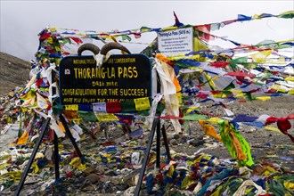 Tibetan prayer flags at sign Thorong-La Pass