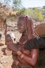 Himba woman with baby in arms