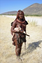 Himba woman with small goat