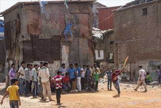 Children and teenagers playing cricket