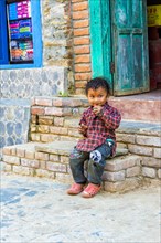Nepalese boy sitting on stairs