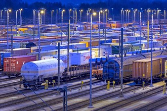 Parked freight cars on tracks at night