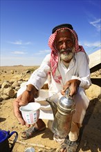 Bedouin preparing coffee with pan-roasted beans and kardamom