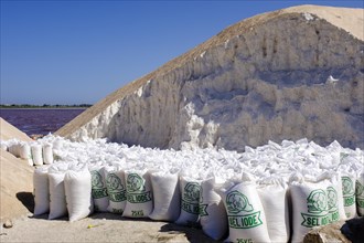 Filled salt sacks next to a salt hill at Lac Rose