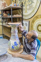 Man working on a mosaic vase