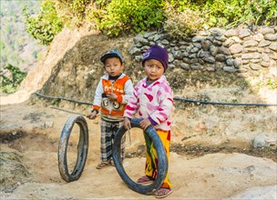 Two little boys with tires as toys