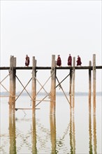 Monks crossing U Bein bridge