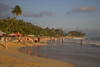 Crowded sandy beach at Mirissa