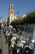 Vespas along the street with cathedral