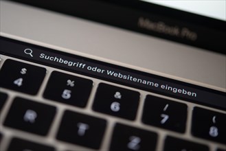Backlit keyboard and Touch Bar showing search bar