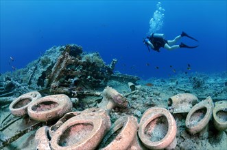 Male scuba diver looking at toilets on the Wreck of Yolanda