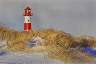Red and white striped lighthouse List East in the dunes