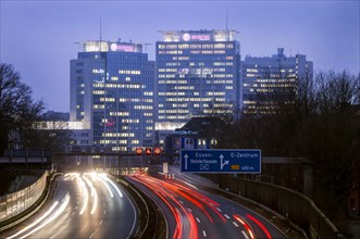 Light trails with A40 in front of the skyscrapers of Evonik