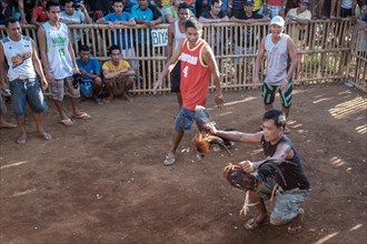 Men gathered at a Sabong Cockfight