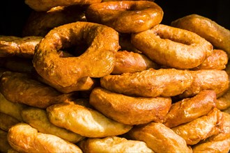 Many fresh doughnuts are piled up for sale
