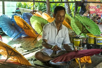 Local man working on multi-colored umbrellas