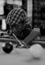 Boy playing billiards