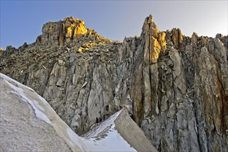 Mountaineers descending from the Cold du Tour mountain pass towards glacier Glacier du Tour