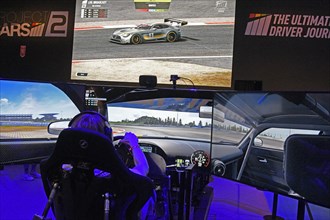 Player sits in a car racing simulation at Gamescom 2017