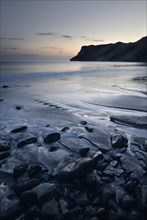 Stones in the sand on the beach of Talisker Bay