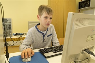 Elementary school student working in computer room