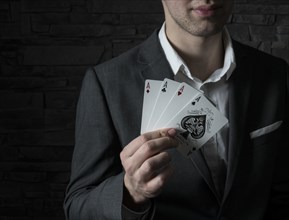 Card artist Jeremy Rowe holds playing cards in his hand