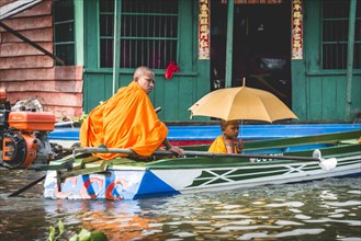 Buddhist monks in motorboat