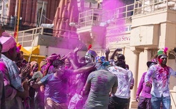 People throwing colored powder