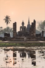 Temple hall Wat Mahathat Sukhothai with witting Buddha