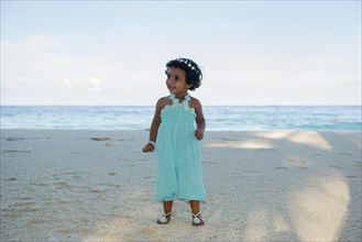 Little Maldivian girl on the sandy beach