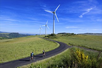 Cyclists on walk in the Cezallier wind farm