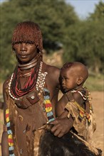 Woman with baby from the Hamer tribe in traditional dress