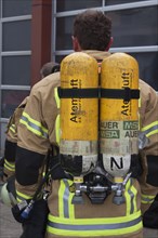 Firefighter with breathing air bottles on his back