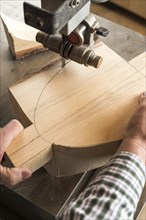 Cutting a wooden block using a band saw