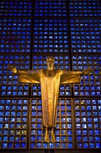 Crucifix in front of a glass facade