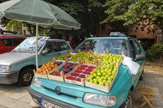 Display of fruit on hood of car