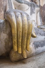 Gilded hand of Phra Atchana Buddha