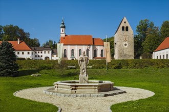 Monastery church with Roman tower and fountain with fountain figure of abbot Walto or Balto