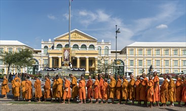 Row of monks in front of ministry of defense