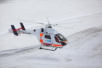Rescue helicopter of the Austrian Red Cross in operation on the Dachstein glacier