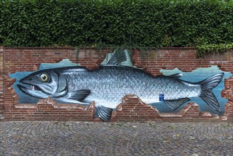 Fish as graffiti on a brick wall