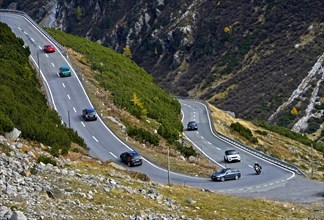 Cars on a mountain road in a hairpin curve